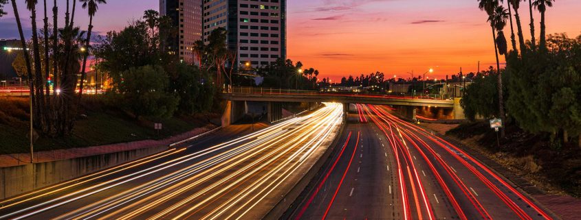 KinseyInvestigations.com Burbank Private Detective - A time-lapse image shows lights from moving traffic against a sunset.