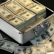 KinseyInvestigations.com Hidden Assets Investigations - A large sum of cash sits inside an open metal case.