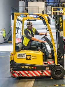 KinseyInvestigations.com Workplace Hazards - A worker operates a forklift.