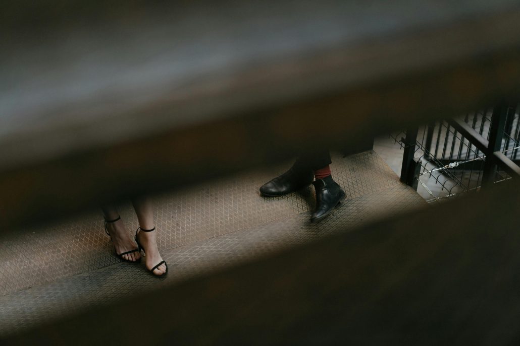 A man's and woman's feet seen through blinds from above - Visit KinseyInvestigations.com. 