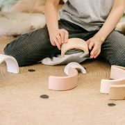 Young boy seen from the neck down playing with blocks - Visit KinseyInvestigations.com.