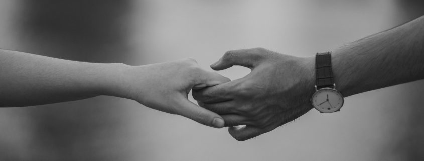 A man's and woman's hands holding onto each other - Visit KinseyInvestigations.com.