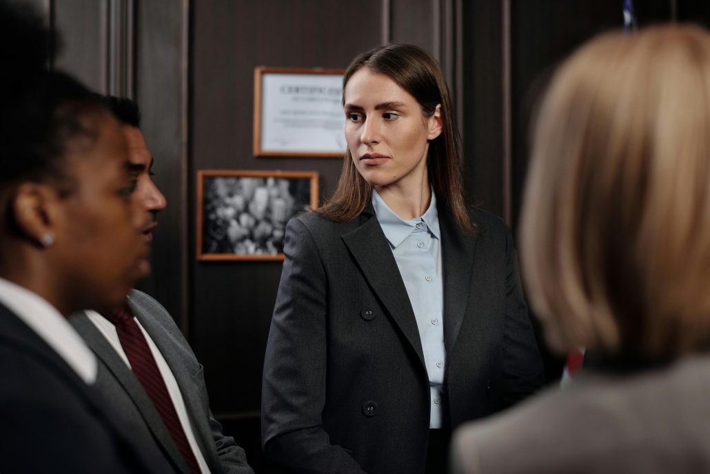 Three women in business suits in coversation.