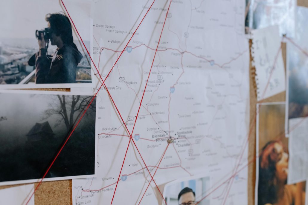 investigation board with maps and photos connected by red string - Visit KinseyInvestigations.com. 