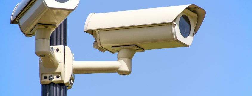 Two surveillance cameras on a post - Visit KinseyInvestigations.com.