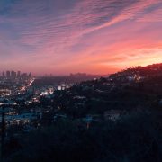 Skyline of Los Angeles seen from surrounding hills at dusk - Consult KinseyInvestigations.com.