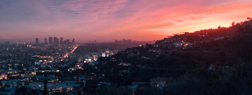 Skyline of Los Angeles seen from surrounding hills at dusk - Consult KinseyInvestigations.com.