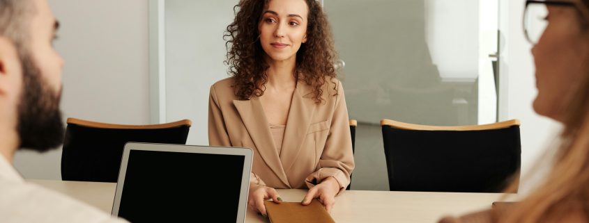 Woman with curly hair at a job interview - Contact KinseyInvestigations.com.