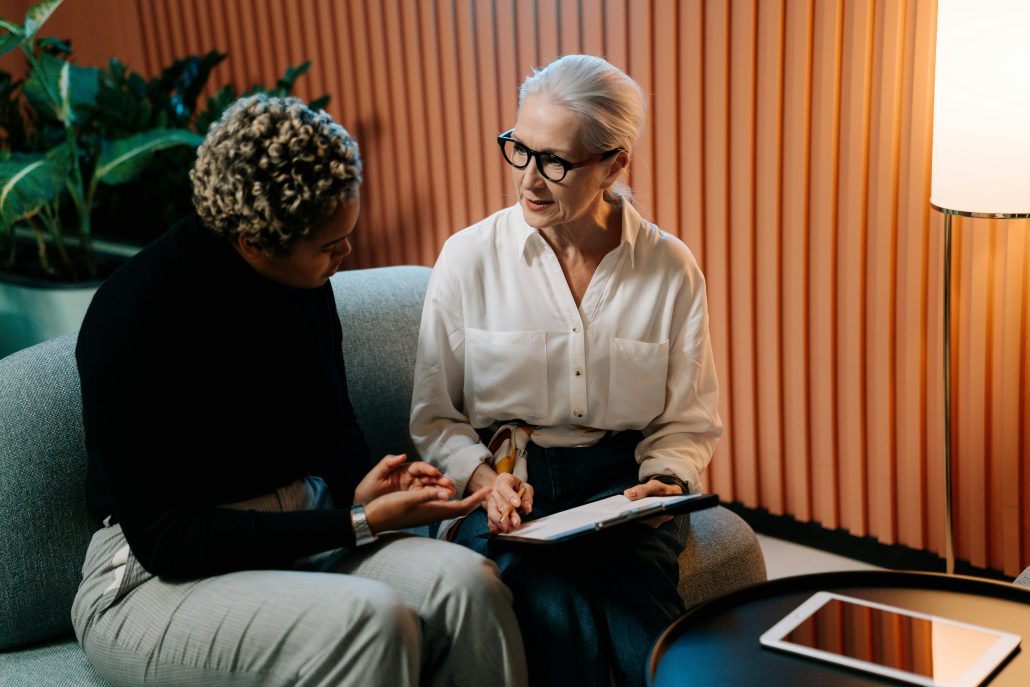 Two mature women consulting a clipboard - Consult Kinsey Investigations.com.